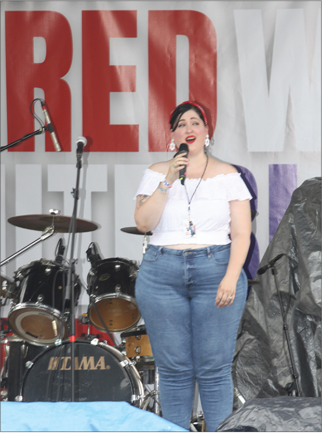 Ashley West-Davis sings the National Anthem at the Red, White and Blue Bash in Uptown Shelby.