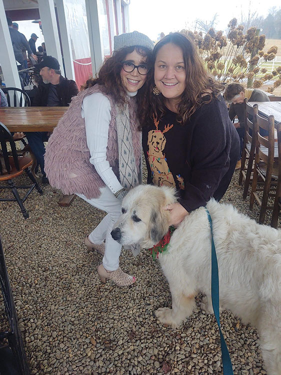 Holly Hopkinns, jazz muscian (left), takes a break from preforming Christmas melodies at the Pet N' Sip fundraiser. She is with Debbie Philbeck and Bi