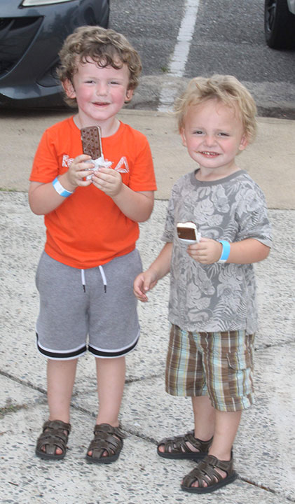 Jess and brother Jauyden Marcum snack on their ice cream sandwiches during the National Carrousel Day Celebration at the Shelby City Park.