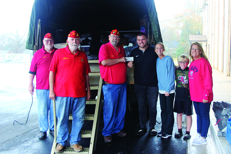 Todd Carpenter (center) Commandant of The NC Foothills Detachment #1164 of the Marine Corps League, presents a check for $1000 to Jeff & Mandy Marburg