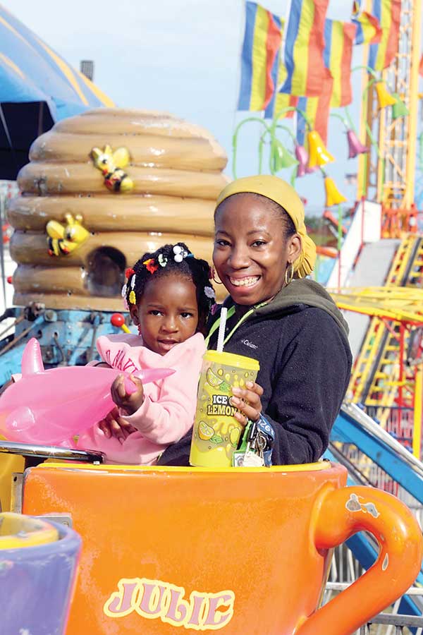 Jaliyah Leach rides the tea cups with her mother Leah Sanders on the Midway at the Cleveland County Fair on Thursday, September 29th. 