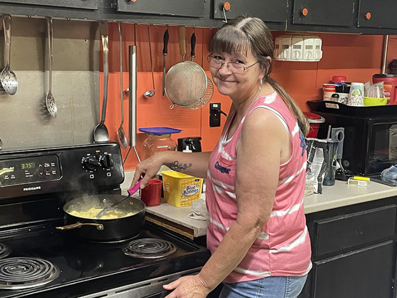 Anna Pruett whips up some scrambled eggs, gravy and grits at the Jaceman breakfast and bake sale.