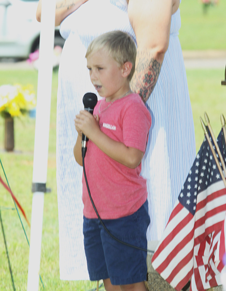 Jaxon Crotts recites the Pledge of Allegiance at the Memorial Day service at Cleveland Memorial Park.  