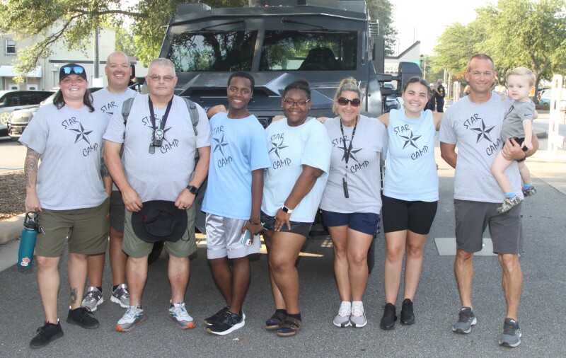 Cleveland County Sheriff's Office resource officers and high school counselors for the Star Camp pose for a photo at National Night Out. 