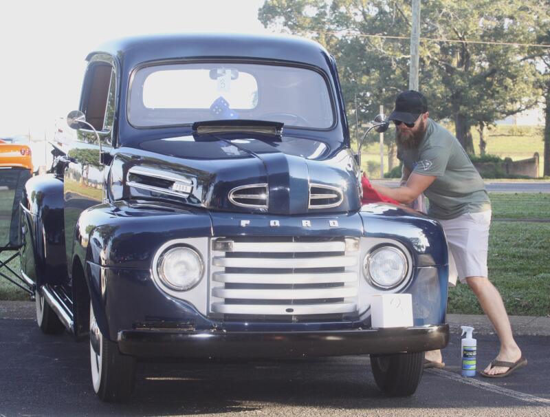 Jacob Jones does some detailing on his beautiful 1950 Ford truck at Sharon Church's second annual car show. 