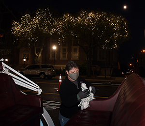 Tricia Woodland, Manager of Marketing and Events for the Uptown Shelby Association cleans carriages between rides on Friday, November 27th.  