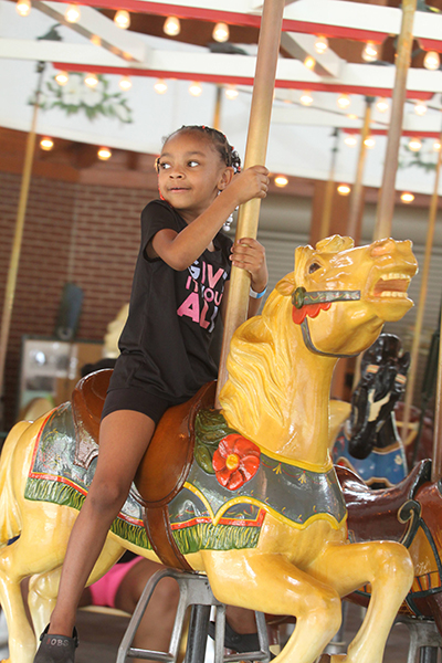 Tank Morgan rides the carrousel during the National Carrousel Day Celebration at Shelby City Park.